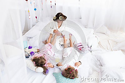 Woman and children on bed Stock Photo