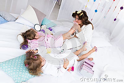 Woman and children on bed Stock Photo