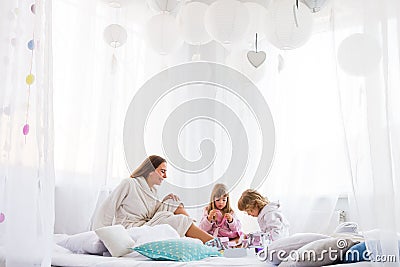 Woman and children on bed Stock Photo