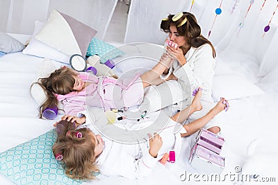 Woman and children on bed Stock Photo