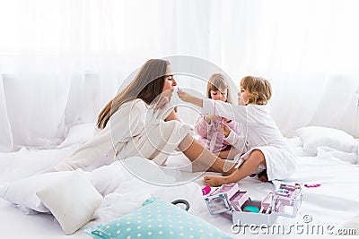 Woman and children on bed Stock Photo