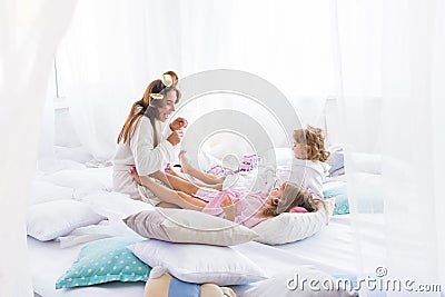 Woman and children on bed Stock Photo