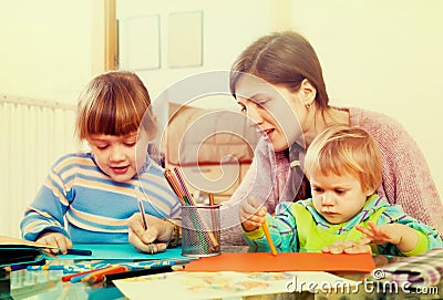 Woman and children together drawing with pencils Stock Photo