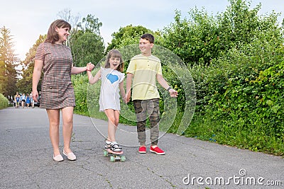 Woman with children for a walk in the park. Happy family Stock Photo