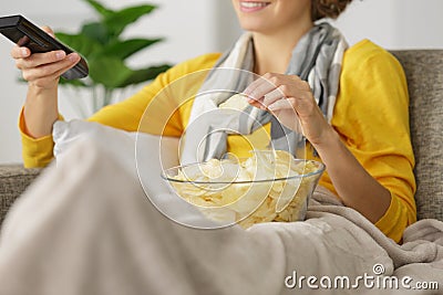 woman with chips while watching tv Stock Photo