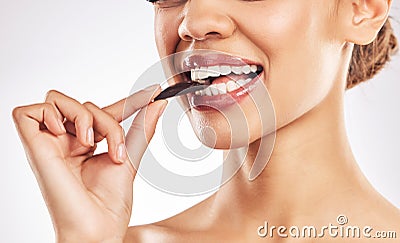 Woman, chocolate and mouth for eating, studio and healthy with nutrition, diet and bite by white background. Girl, model Stock Photo