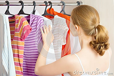 Woman chooses clothes in the wardrobe closet at home Stock Photo