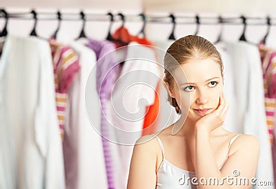 Woman chooses clothes in the wardrobe closet at home Stock Photo