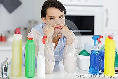 Woman choosing betwwen cleaning products Stock Photo