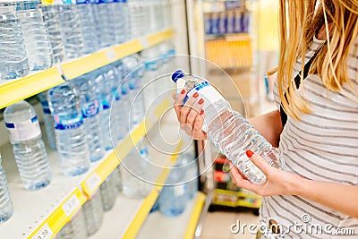 Woman choosing bottled mineral water Stock Photo