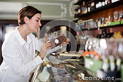 Woman choosing chocolate bar Stock Photo