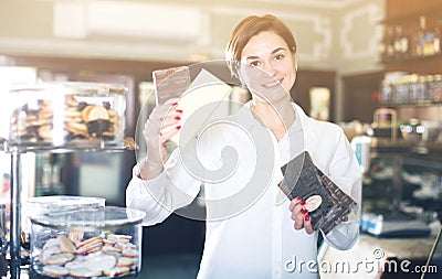 Woman choosing chocolate bar Stock Photo