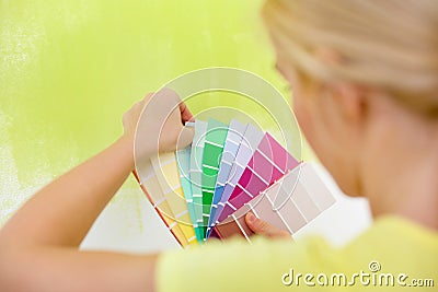 Woman choosing color for wall Stock Photo