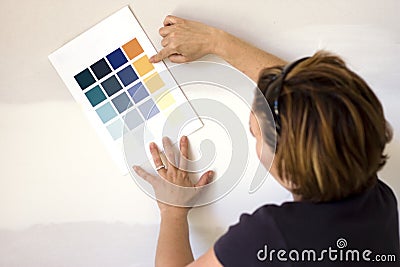 Woman choosing paint color for wall Stock Photo