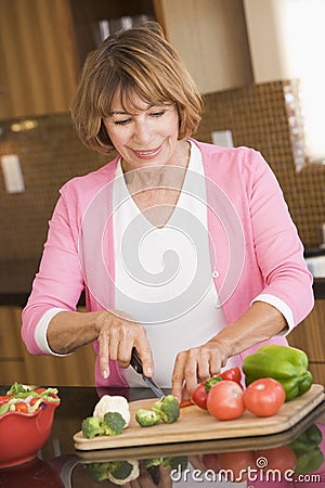 Woman Chopping Vegetables Stock Photo