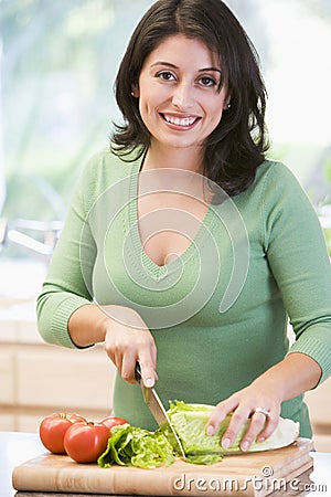 Woman Chopping Vegetables Stock Photo
