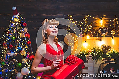 Woman in Christmas dress near the Christmas tree. Christmas preparation - luxury girl celebrating new year. Merry Stock Photo