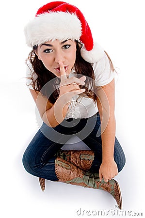 Woman with christmas hat and asking to keep silent Stock Photo