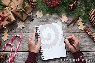 Woman Christmas letter on paper on wooden background Stock Photo