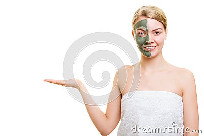 Woman in clay mud mask on face holds open palm Stock Photo