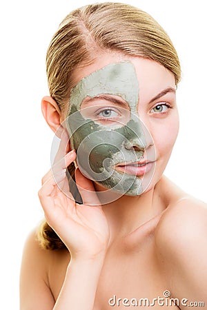 Woman in clay mud mask on face isolated on white. Stock Photo