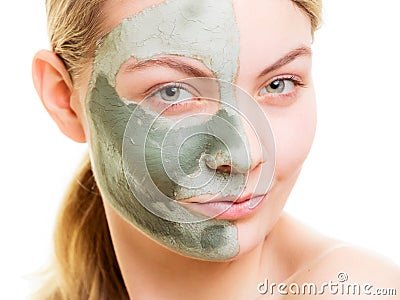 Woman in clay mud mask on face isolated on white. Stock Photo