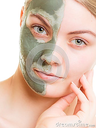 Woman in clay mud mask on face isolated on white. Stock Photo