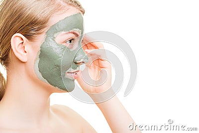 Woman in clay mud mask on face isolated on white. Stock Photo
