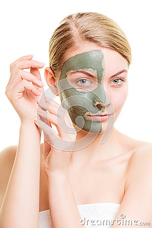Woman in clay mud mask on face isolated on white. Stock Photo