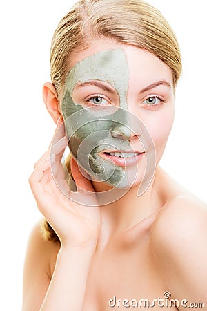 Woman in clay mud mask on face isolated on white. Stock Photo