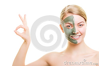 Woman in clay mud mask on face isolated on white. Stock Photo