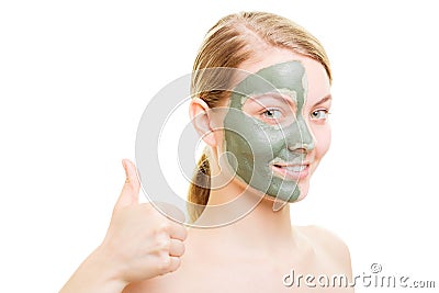 Woman in clay mud mask on face isolated on white. Stock Photo