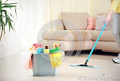 Woman clean the floor,girl clean up the room,bucket with sanitary items Stock Photo