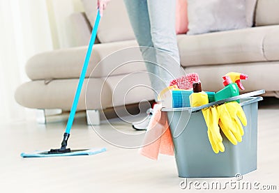 Woman clean the floor,girl clean up the room,bucket with sanitary items Stock Photo