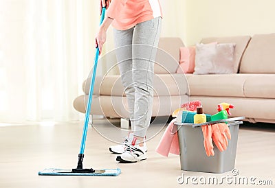 Woman clean the floor,girl clean up the room,bucket with sanitary items Stock Photo