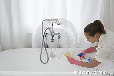 Woman Cleaning Bathtub Stock Photo