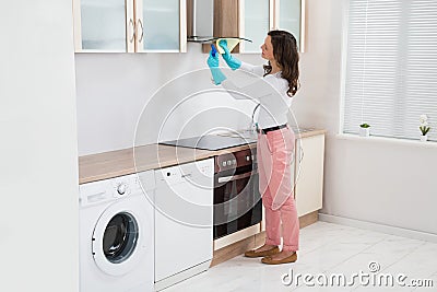 Woman Cleaning Cooker Hood Stock Photo