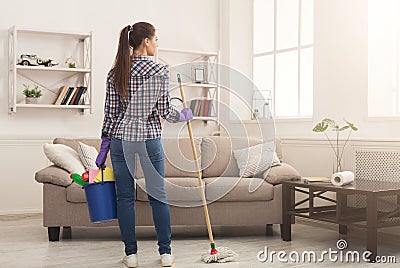 Woman with cleaning equipment ready to clean room Stock Photo