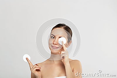 Woman Cleaning Face With White Pad. Beautiful Girl Removing Makeup White Cosmetic Cotton Pad. Stock Photo