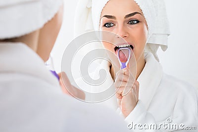 Woman cleaning her tongue Stock Photo