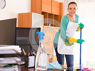 Woman cleaning office room Stock Photo