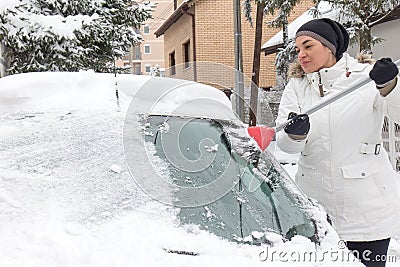 Woman cleaning snow Stock Photo