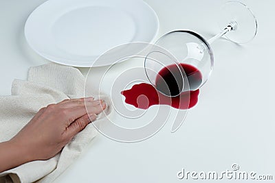 Woman cleaning spilled wine on white background, closeup Stock Photo