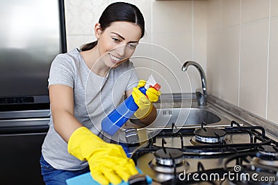 Woman cleaning stove Stock Photo