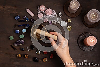 Woman cleansing healing chakra crystals with tibetan singing bowl. Rituals with gemstones for wellness Stock Photo