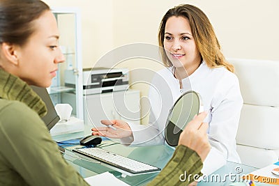 Woman client checking result of beauty procedures Stock Photo