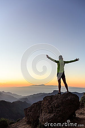Woman climber success silhouette in inspiring mountains Stock Photo