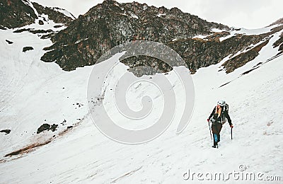 Woman climbing with ice axe mountaineering Travel Stock Photo