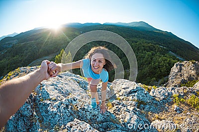 A woman is climbing a stone Stock Photo