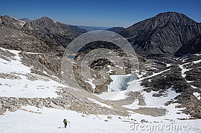 Woman Climbs Up Snowfield Stock Photo